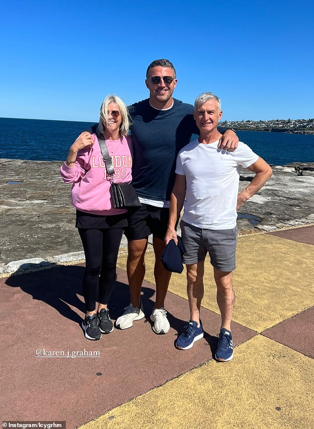 NRL star Sam Burgess, 34, enjoyed some time with his future in-laws at Coogee in Sydney on Saturday.  Pictured center with his pregnant fiancée Lucy's mother Karen and father David