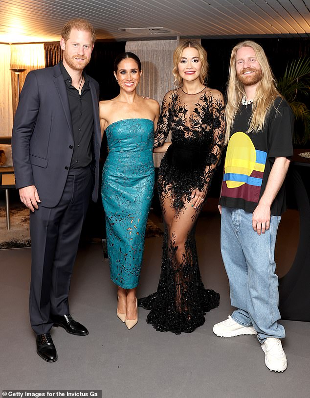 Meghan and Prince Harry appeared in good spirits as they joined celebrity friends Rita Ora and Sam Ryder (right) at the Invictus Games