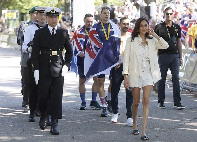 Meghan Markle (pictured) was filmed today as she marched with the cycling medalists at the Invictus Games in Germany