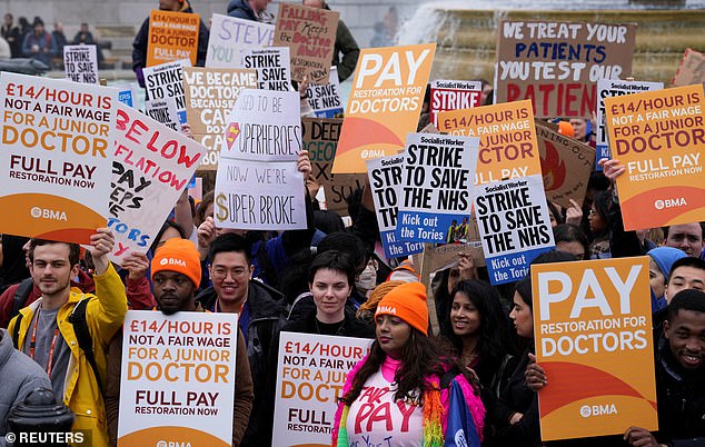 Junior doctors hold signs during a strike, amid a dispute with the government over pay, in London on April 11 (file photo)