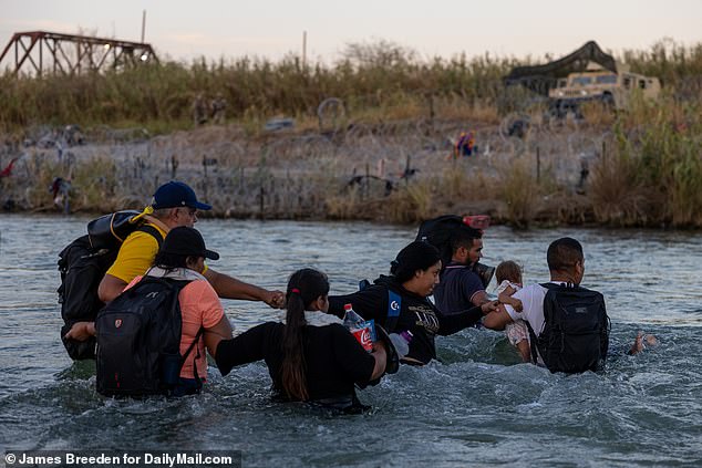 Migrants cross the Rio Grande River from Piedras Negras, Mexico to Eagle Pass on Friday