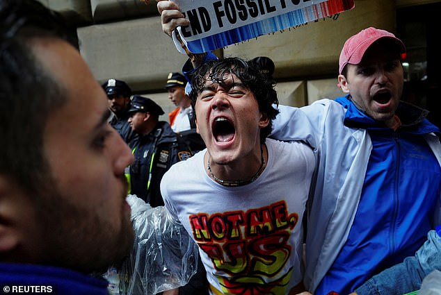 Climate activists demanding an end to fossil fuel financing were arrested Monday at the Federal Reserve Bank of New York