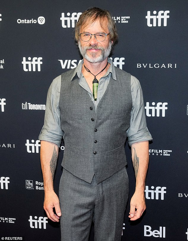 Guy Pearce, 55, (pictured) showed off his rugged arm tattoos on Friday as he walked the red carpet for a special screening of The Convert at the Toronto International Film Festival