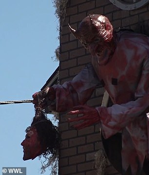 A blood-stained Satan holding the head of Jesus