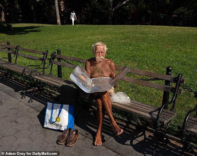 Some New Yorkers are embracing the heat wave late in the season.  Here, a man committed to his tan sunbathes with a reflector in Washington Square Park