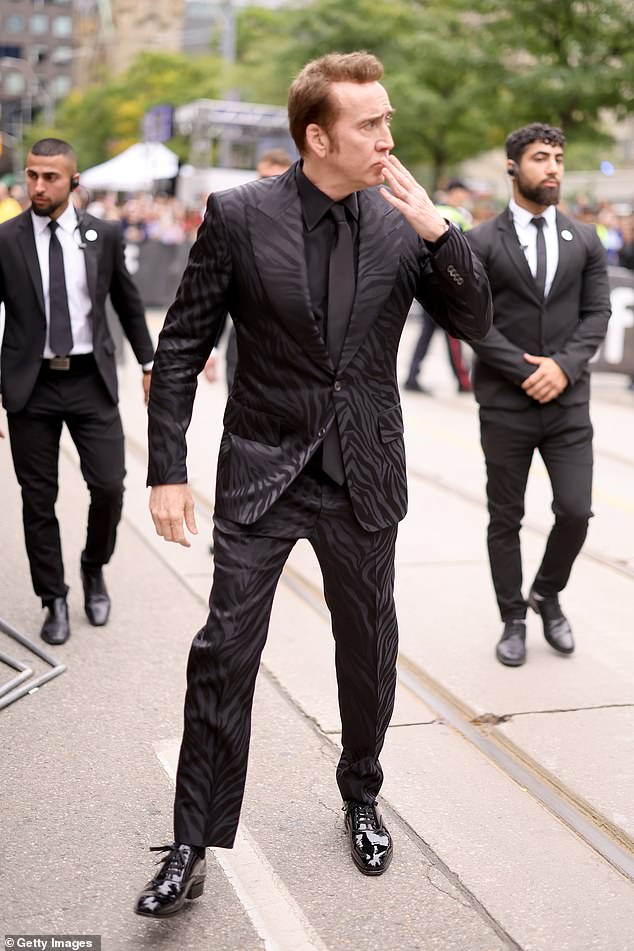 Fan Friendly: Old Hollywood leading man let screaming fans know he appreciated them with a look and a wave before hitting the red carpet