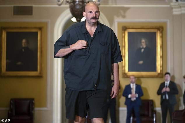 Sen. John Fetterman, D-Pa., walks through the Capitol wearing shorts on Thursday, September 21, 2023.  Senior senators from both parties are complaining about a change that ended the Senate dress code, allowing him to wear a hoodie