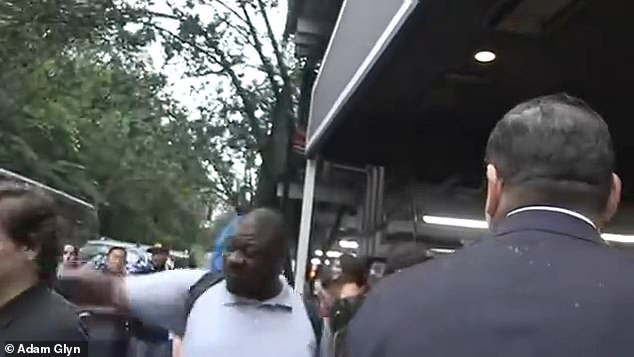 The heavyset fan punches the star's assistant in the back of the head after failing to get an autograph