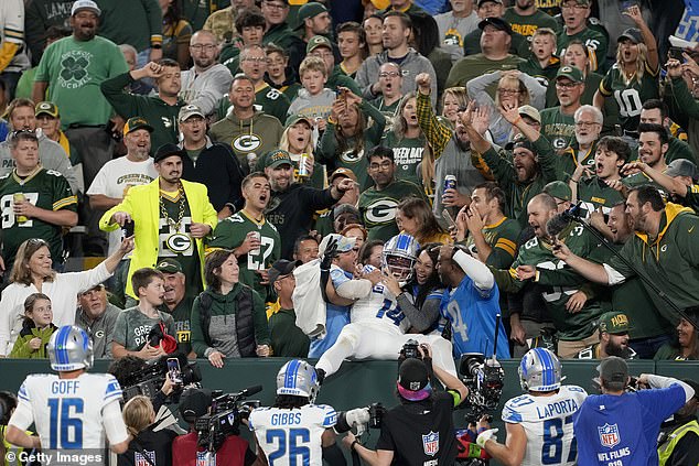 A Green Bay Packers fan poured beer over the Detroit Lions' Amon-Ra St. Brown