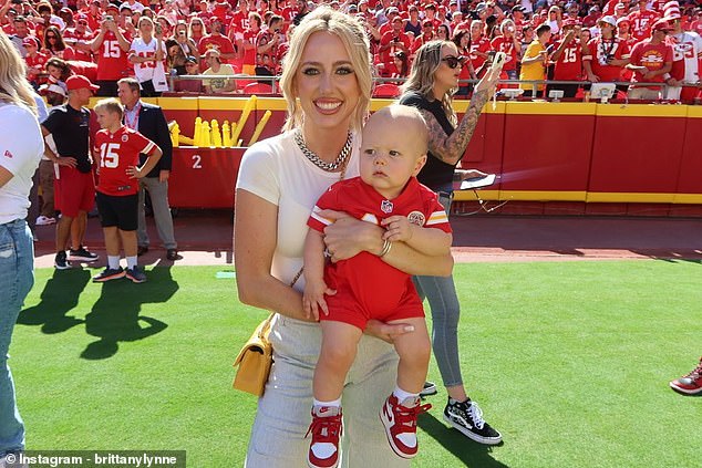 Brittany Mahomes poses with her 10-month-old son Bronze during his very first NFL game