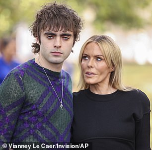 Bold: Lennon oozed Burberry style as he wore dark green tartan trousers, with a pair of green boots and opted for an autumn jumper for the fashion show