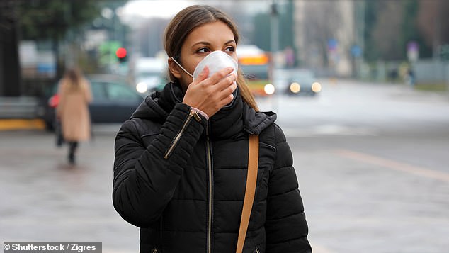 The Pirola variant of Covid, which experts say is the 'real deal', has been found for the first time in Australia.  The photo shows a woman wearing a face mask