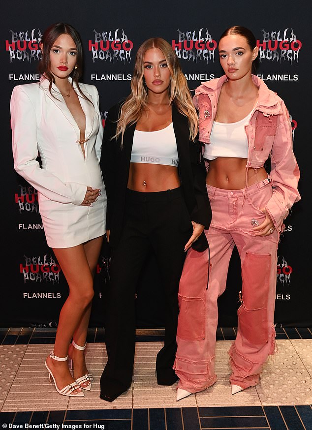 Sisters!  Pregnant Phoebe Tomlinson, 19, joined her beaming sisters Daisy, 19, and Lottie, 25, at the launch of the HUGO x Bella Poarch collection at Flannels in London on Friday