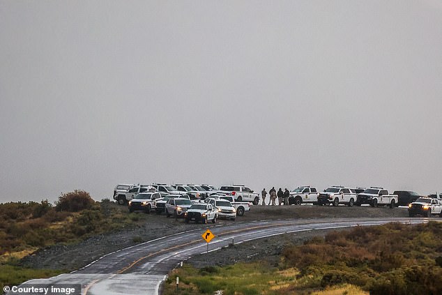 Police and rangers move to higher ground as Burning Man was brought to a halt Friday during an unprecedented downpour in Nevada's Black Rock Desert