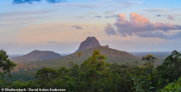 Residents of a rural town in central Queensland have been told to 'leave immediately' as a fast-moving bushfire burns its way towards people and homes, putting 'lives at risk'.  A second fire is burning in the Glass House Mountains National Park (pictured) near Beerwah on the Sunshine Coast