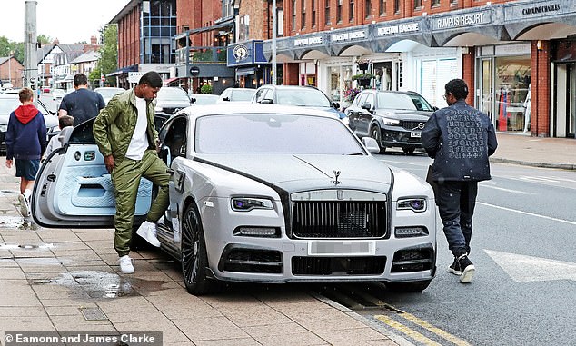 Rashford (left) was previously seen getting into his luxury Rolls Royce at a jewelers in Cheshire