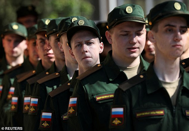 Russian conscripts called up for military service line up for their departure to garrisons as they gather at a recruitment center in Simferopol, Crimea, April 25, 2023