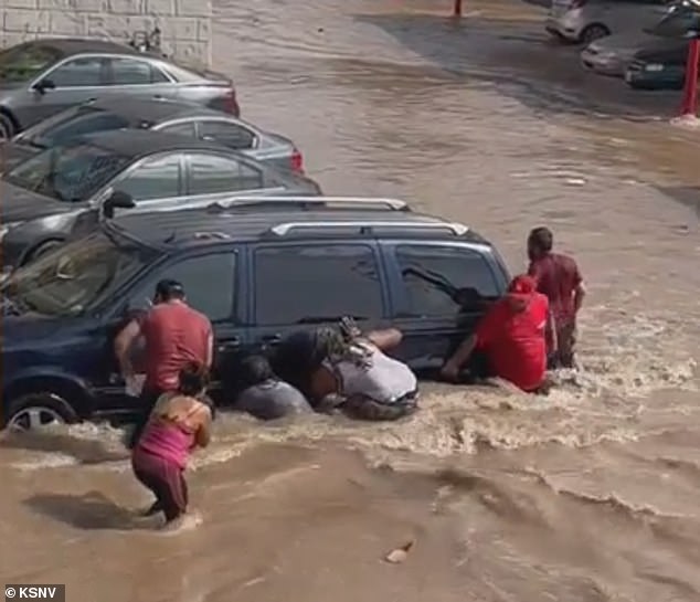 Dramatic cell phone video shows family, neighbors and even strangers trying to rescue the young boy from under an SUV after playing in the water