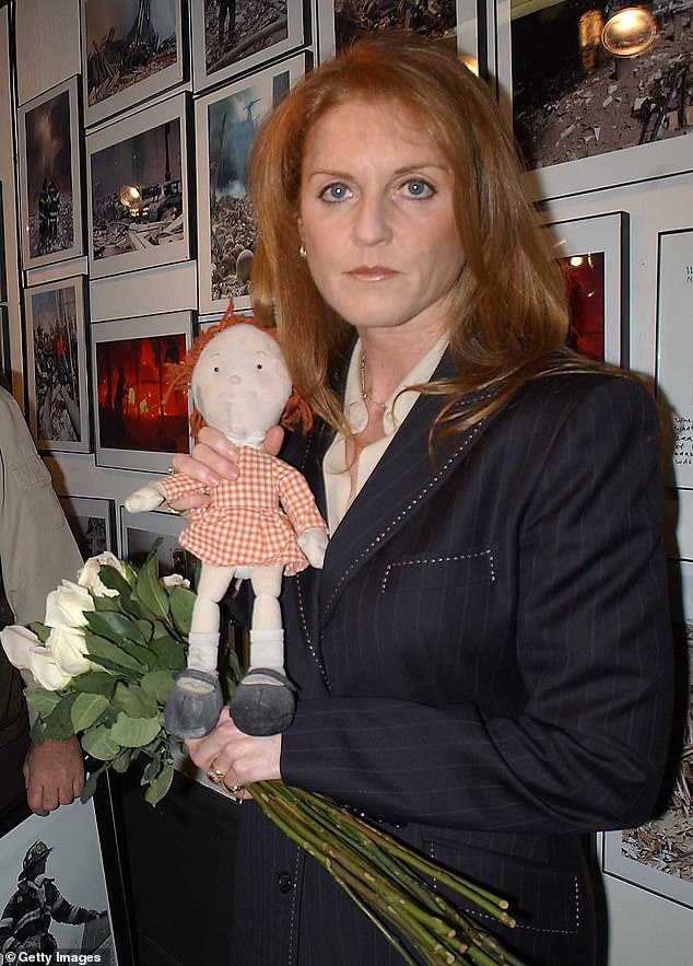 Sarah Ferguson poses with her charity mascot Little Red at the World Trade Center photography exhibition in New York in 2002