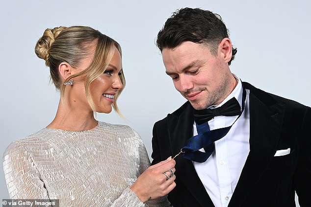 Lachie Neale (pictured with wife Julie after winning the Brownlow) was shocked to win the award for a second time, joining rare company in the AFL as a dual recipient