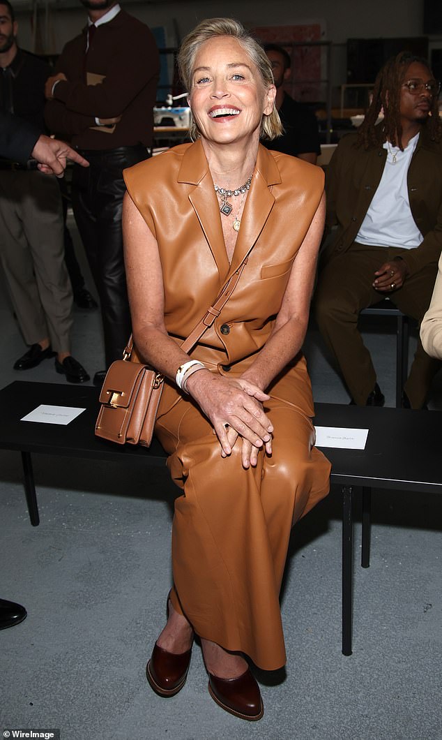 Gorgeous: Sharon Stone, 65, looked divine in a tan leather vest and matching trousers as she led the stars as they sat front row at Tod's Milan Fashion Week show in Italy on Friday