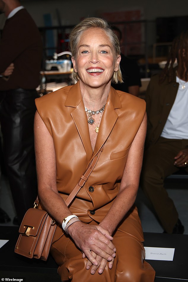 Stylish: The Hollywood icon, adorned with a gold coin necklace and a statement chunky chain, as she enjoyed looking at the brand's latest collection, displayed in style