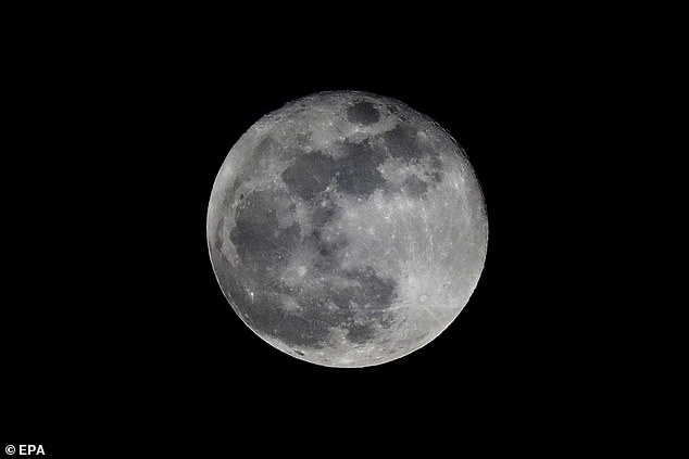 September's blue harvest moon hangs in the night sky in Panama City, Panama