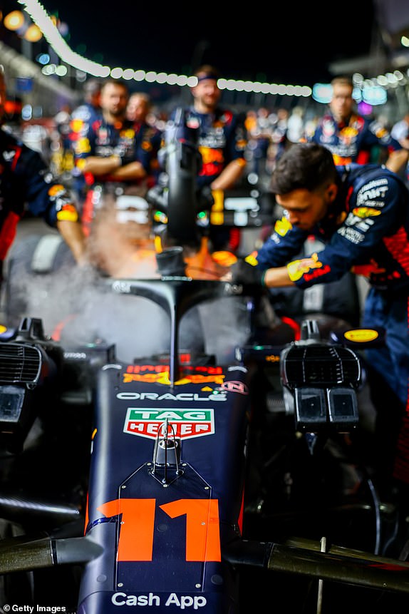 SINGAPORE, SINGAPORE – SEPTEMBER 17: The car of Sergio Perez of Mexico and Oracle Red Bull Racing is prepared on the grid ahead of the F1 Grand Prix of Singapore at Marina Bay Street Circuit on September 17, 2023 in Singapore, Singapore.  (Photo by Mark Thompson/Getty Images)