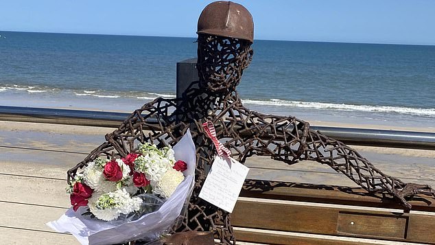 A bouquet of flowers and a birthday message left on a sculpture of a man on a beach (pictured) claim that Austrian man Carl Josef Halban is the real 'Somerton Man'