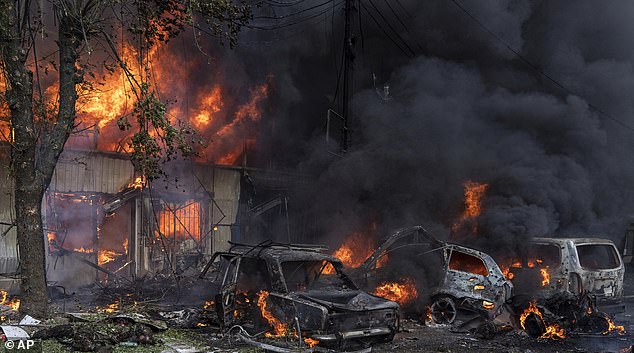 Cars are on fire in a scene of devastation as the market burns after Russian shelling