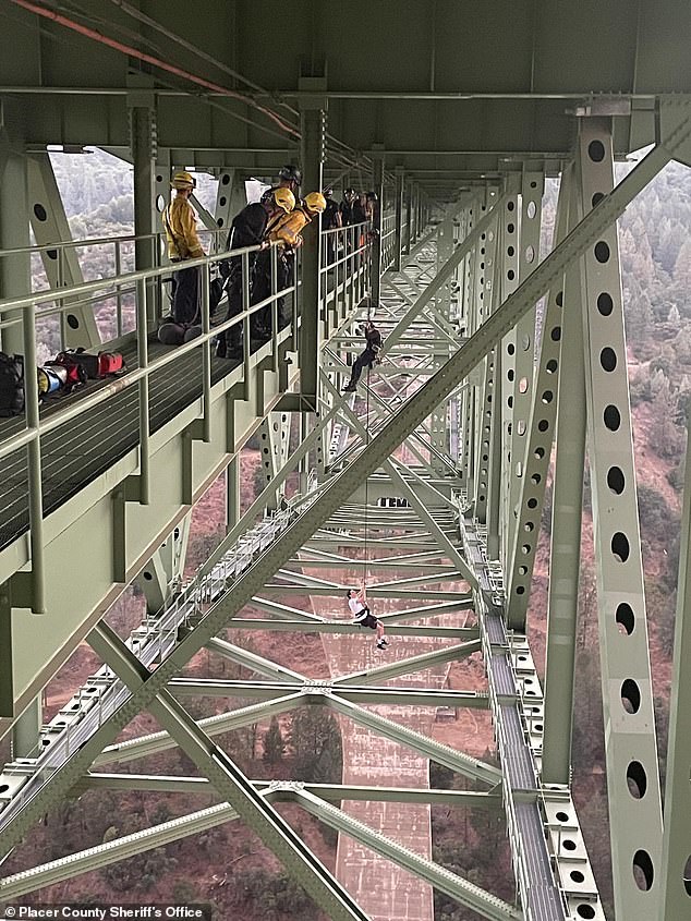 A 19-year-old had to be rescued after becoming stuck in the air, hanging from a California bridge more than 700 feet above the ground in Placer County.