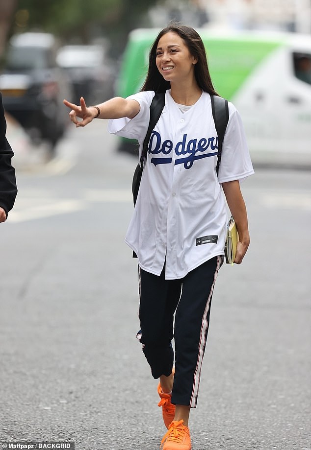 Excited: Katya Jones, 34, put on a sporty performance in a graphic white T-shirt as she left Radio 5 Live Studios on Sunday