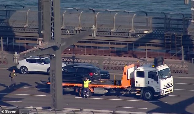 Footage from the scene shows a black hatchback being attached to a tow truck