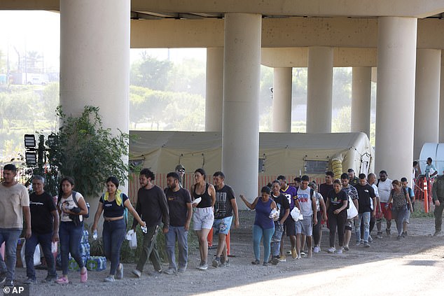 Thousands of migrants line up to be processed upon arrival at Eagle Pass, Texas, on Wednesday.  At one point the line stretched for five miles