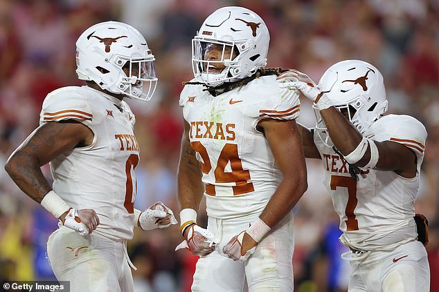 Jonathon Brooks #24 of the Texas Longhorns celebrates with teammates after the 34-24 win