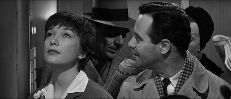 Jack Lemmon watches Shirley MacLaine in the company elevator in The Apartment.