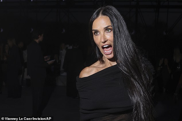 Beaming: Demi Moore put on an animated show as she attended the Saint Laurent Womenswear Spring/Summer 2024 show during Paris Fashion Week on Tuesday