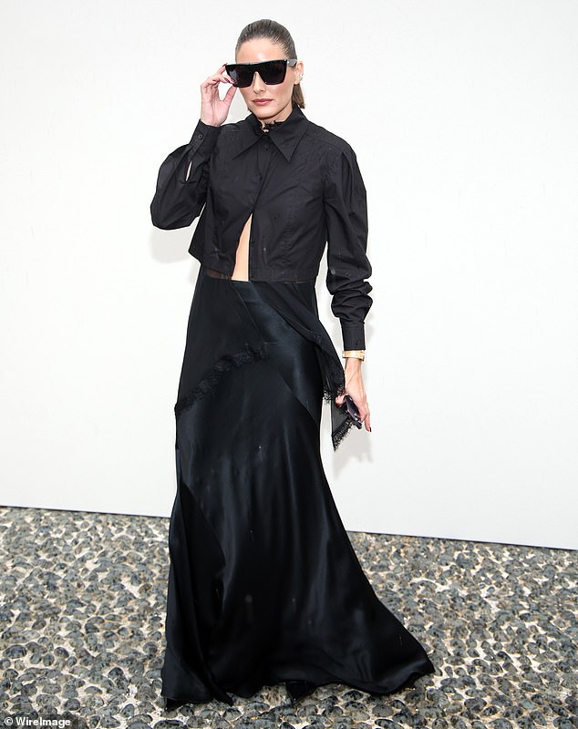 Attention-grabbing: Meanwhile, Olivia Palermo turned heads in a dramatic black shirt with the bottom left unbuttoned.