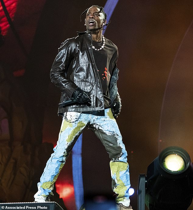 Claim: Travis Scott's lawyers have claimed his phone was lost at sea after falling from a boat - after lawyers representing claimants in the 2021 Astroworld tragedy asked him to hand over his phone records - pictured on day 1 of the Astroworld Music Festival at NRG Parkeer on Friday, November 5, 2021 in Houston