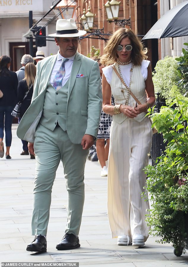 Something to tell us?  Trinny Woodall was spotted walking down the street with a mystery man on Saturday following her divorce from Charles Saatchi