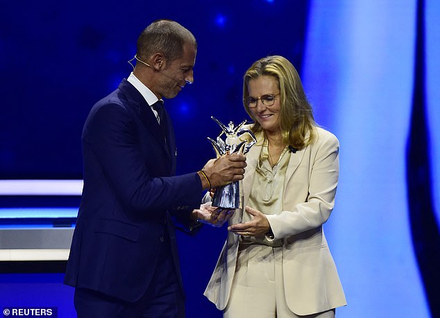 UEFA President Aleksander Ceferin presents the Coach of the Year trophy to England manager Sarina Wiegman in Monaco