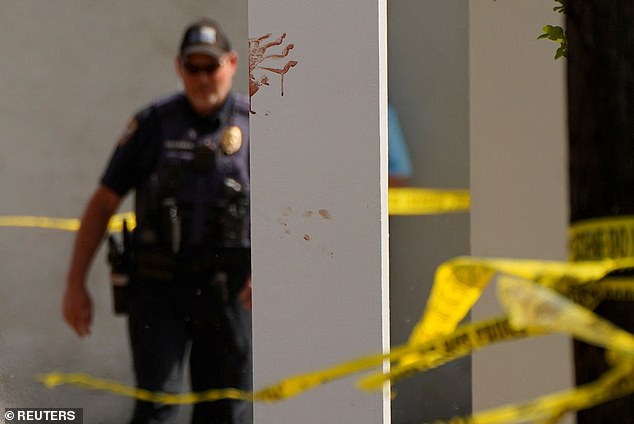 A bloody handprint marks a pillar the day after a shooting during a teenager's birthday party at Mahogany Masterpiece Dance Studio in Dadeville, Alabama
