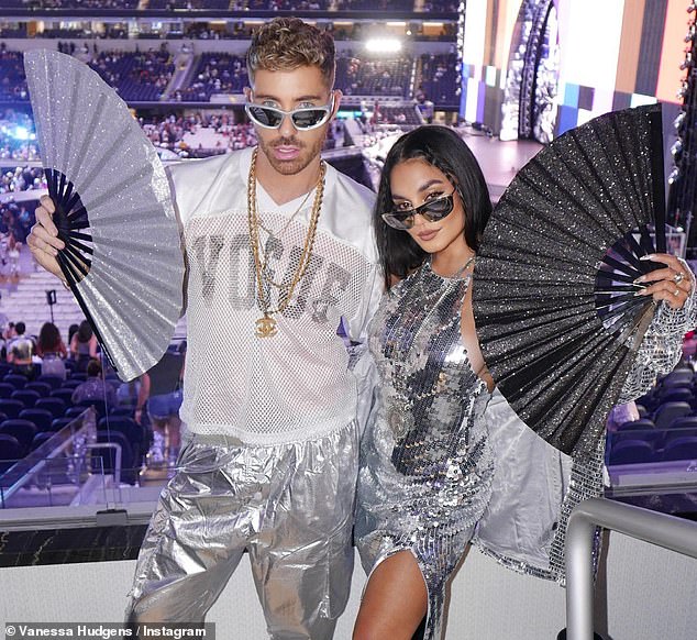 Fun night: Vanessa waved a sparkly black fan as she posed for fun photos with her friends