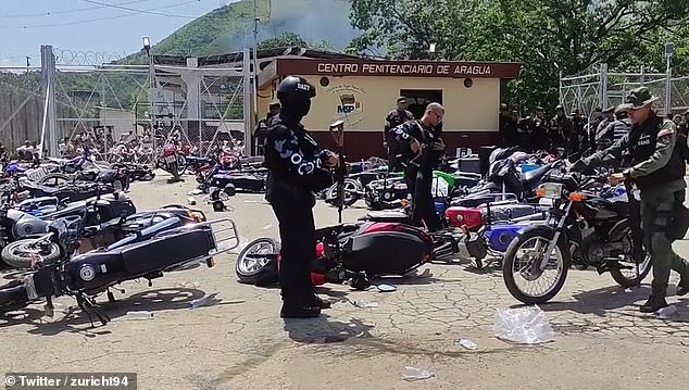 Police and soldiers inspect the motorcycles found on Wednesday at the Tocorón prison center in Aragua, Venezuela