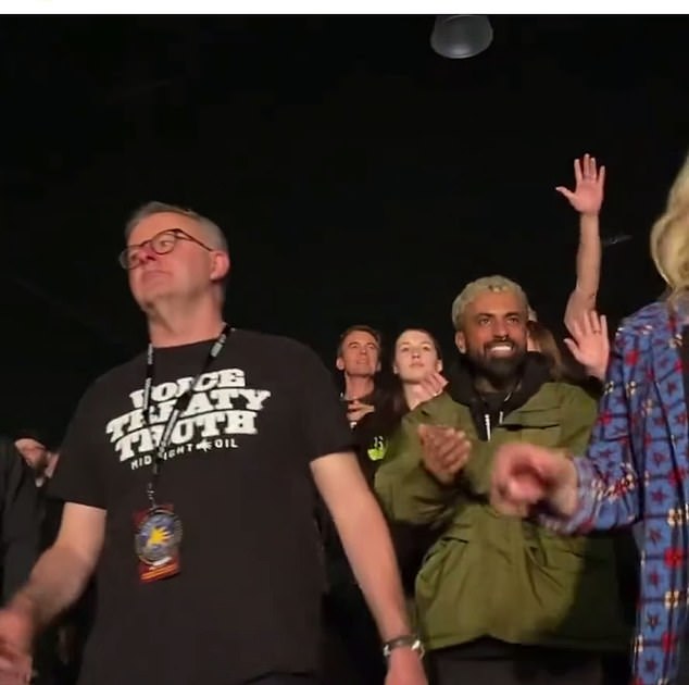 Just over a third of Australians (36 percent) say they will vote Yes to the Voice to Parliament, according to the Newspoll survey of 1,239 voters (Prime Minister Anthony Albanese is pictured delivering a 'Voice, Treaty' at a Midnight Oil concert ' wears, T-shirt of truth)