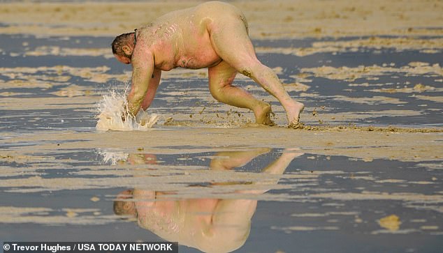 Los Angeles 'Dirty D' dives into the mud at Burning Man