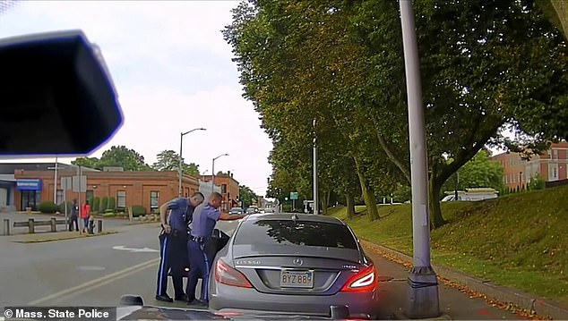 The video begins with the two officers talking to the suspect while someone leans on the car