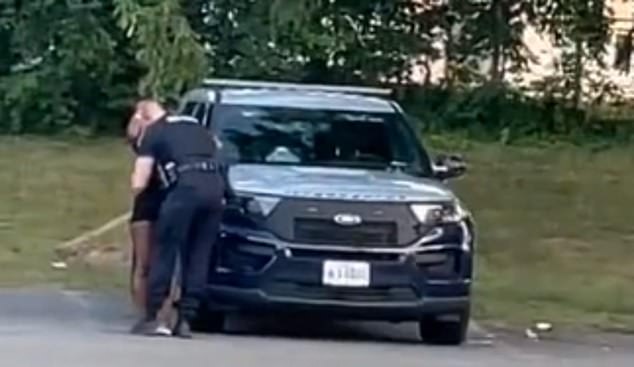 Maryland police officer caught on camera passionately making out with a woman next to his patrol vehicle before climbing into the backseat with her has been suspended