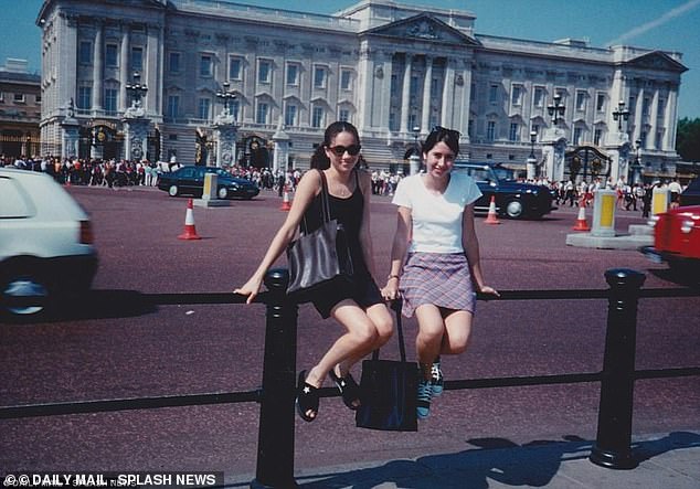 A 15-year-old Meghan Markle poses in front of Buckingham Palace with childhood friend Ninaki Priddy in 1996