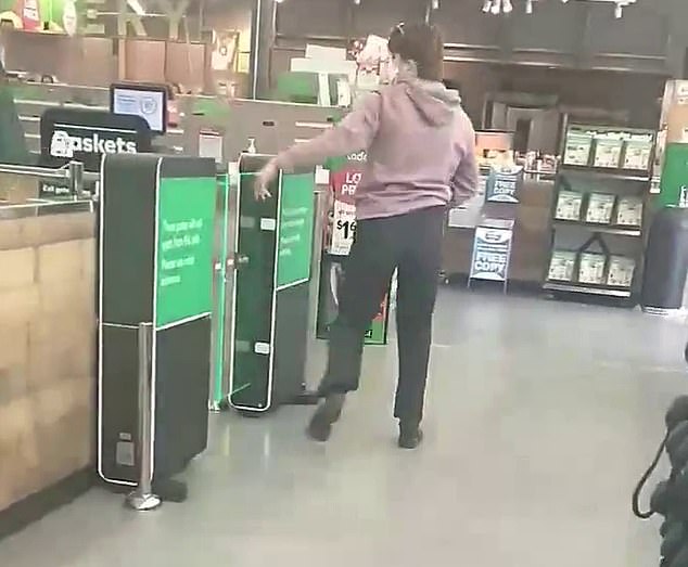 Shocking footage has emerged of the moment a Woolworths shopper used a hammer to smash the stunned gates of the supermarket's self-service checkout